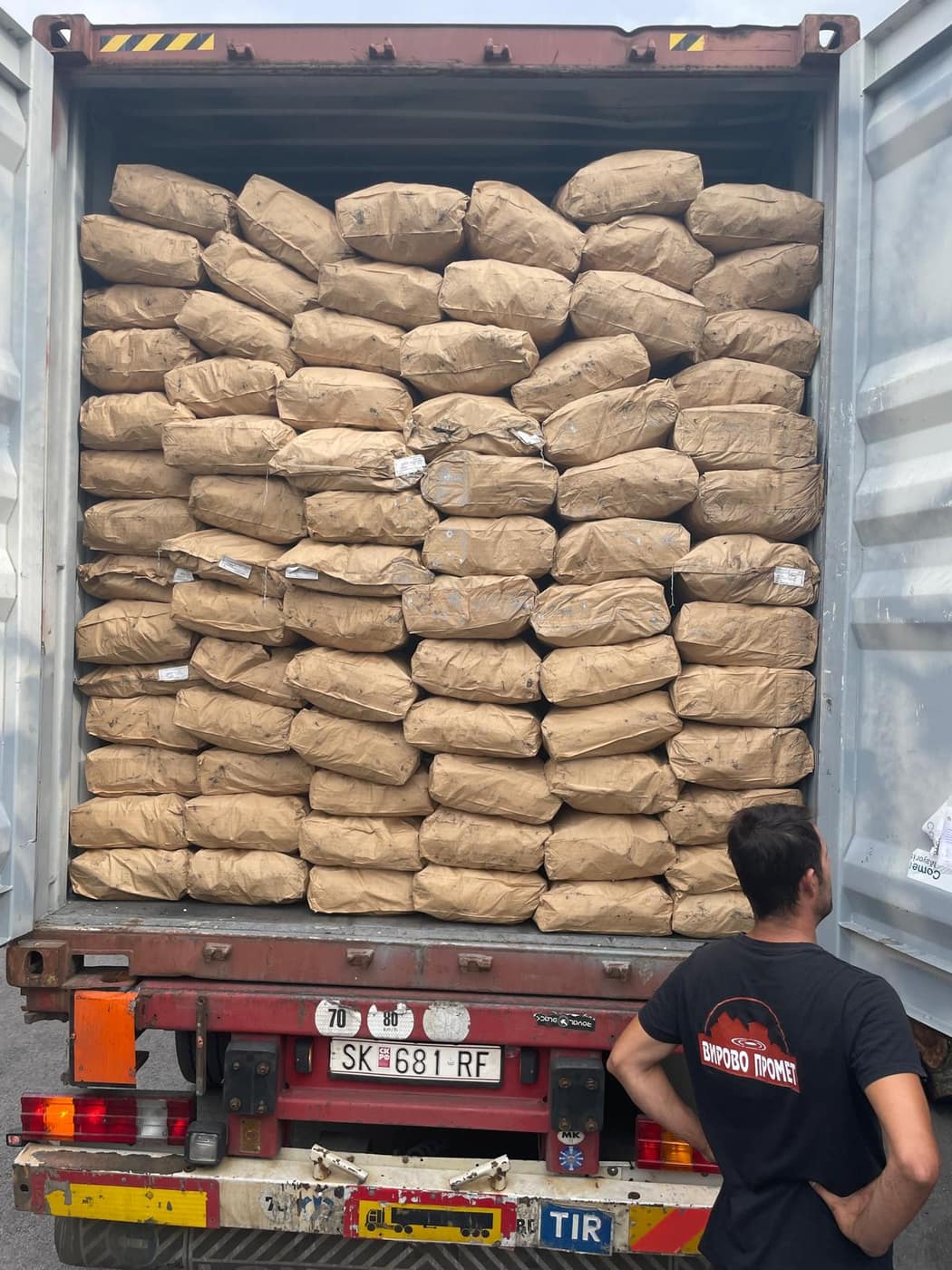 Workers loading a full container for export